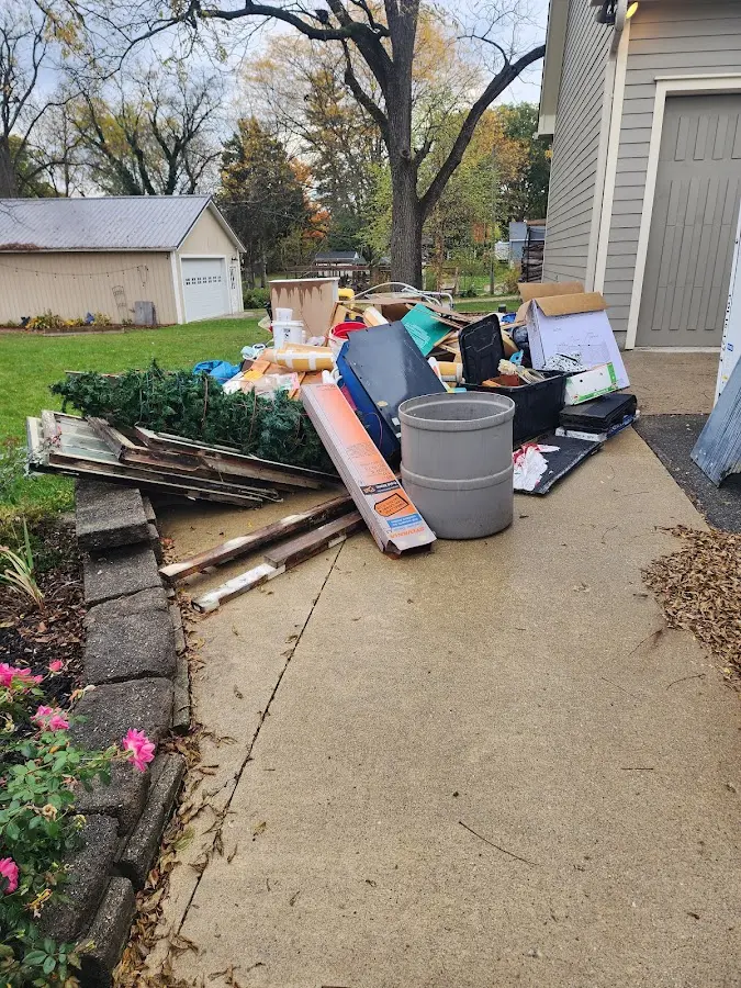 Dumpster being loaded with debris for Estate Cleanout Dumpster Rental in Catoosa